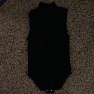 Black top that is supposed to be tucked in